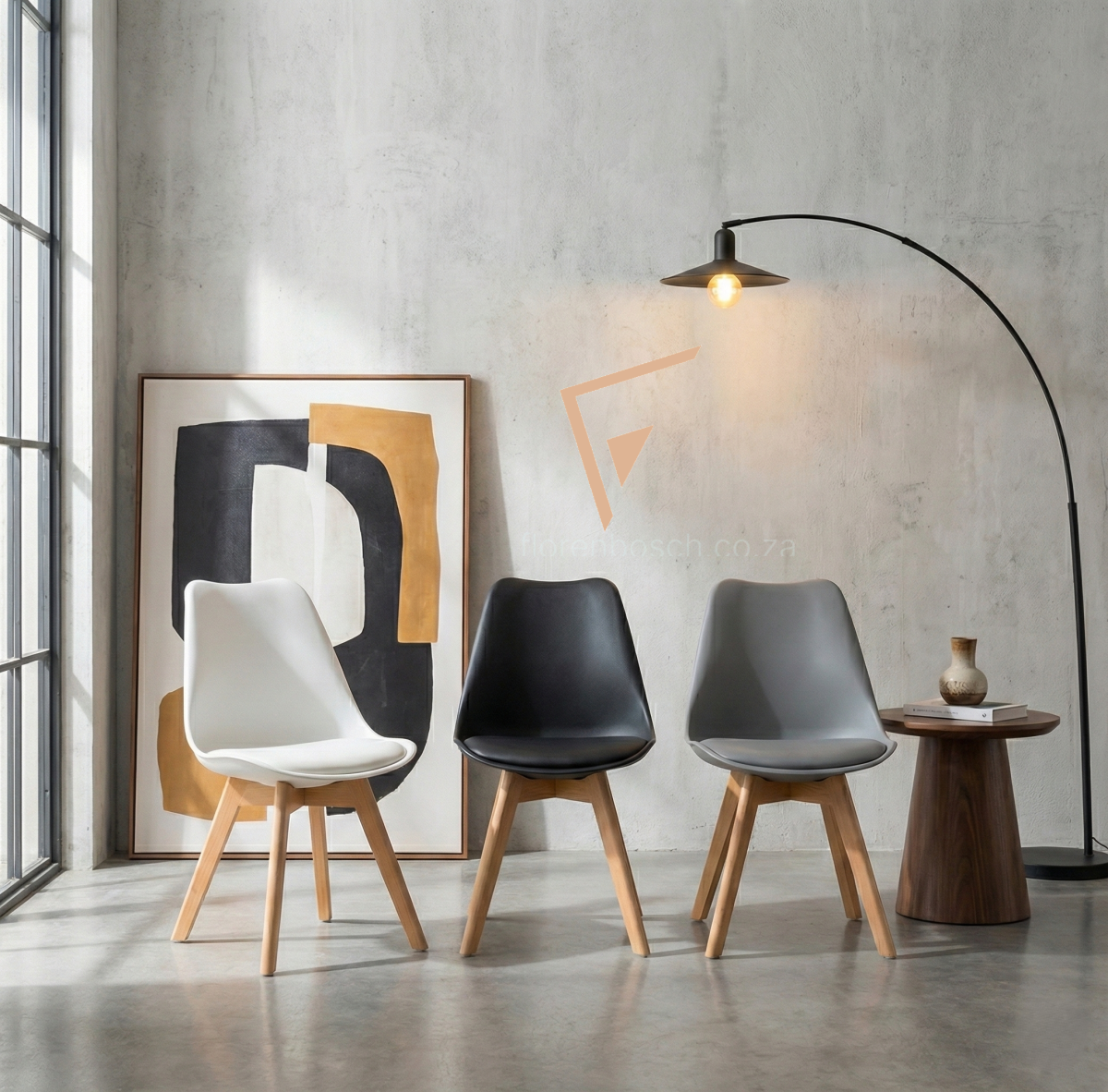 Modern dining chairs in a living room setting with industrial lamp and abstract art.